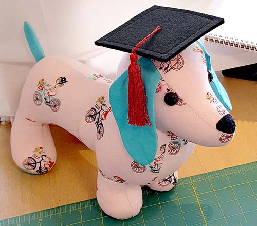Dachshund toy graduation cap sewn by Korina Fraser